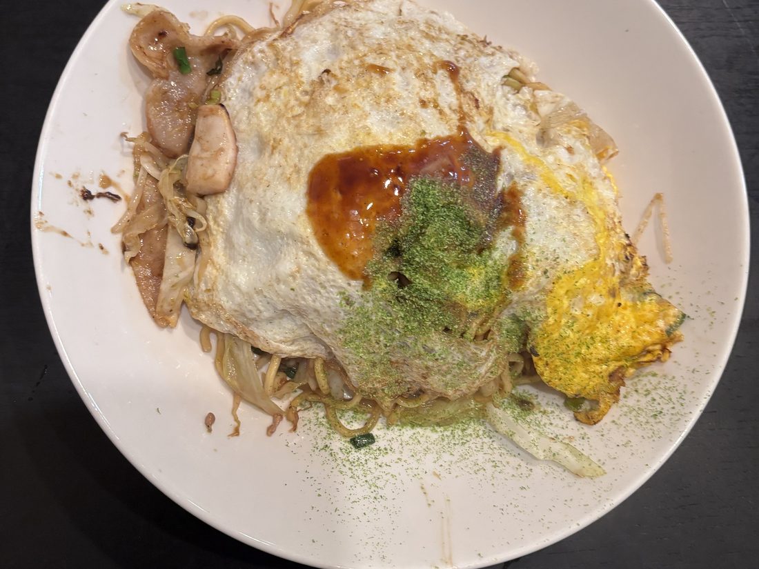 目玉焼きをのせ、ソースと青のりをかけた焼きソバ